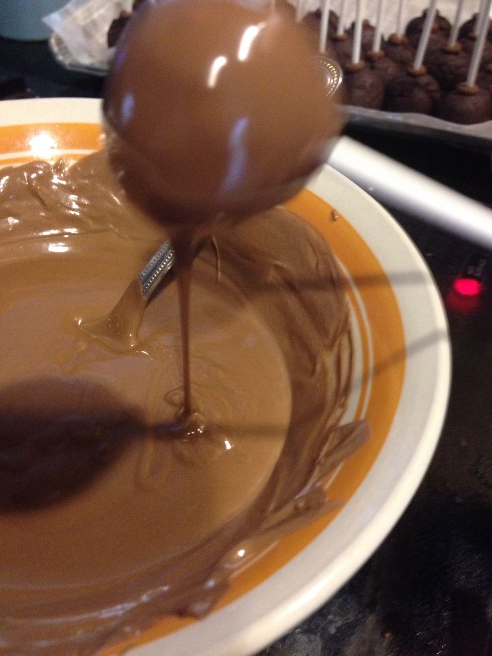 Tap off the excess chocolate back into the bowl