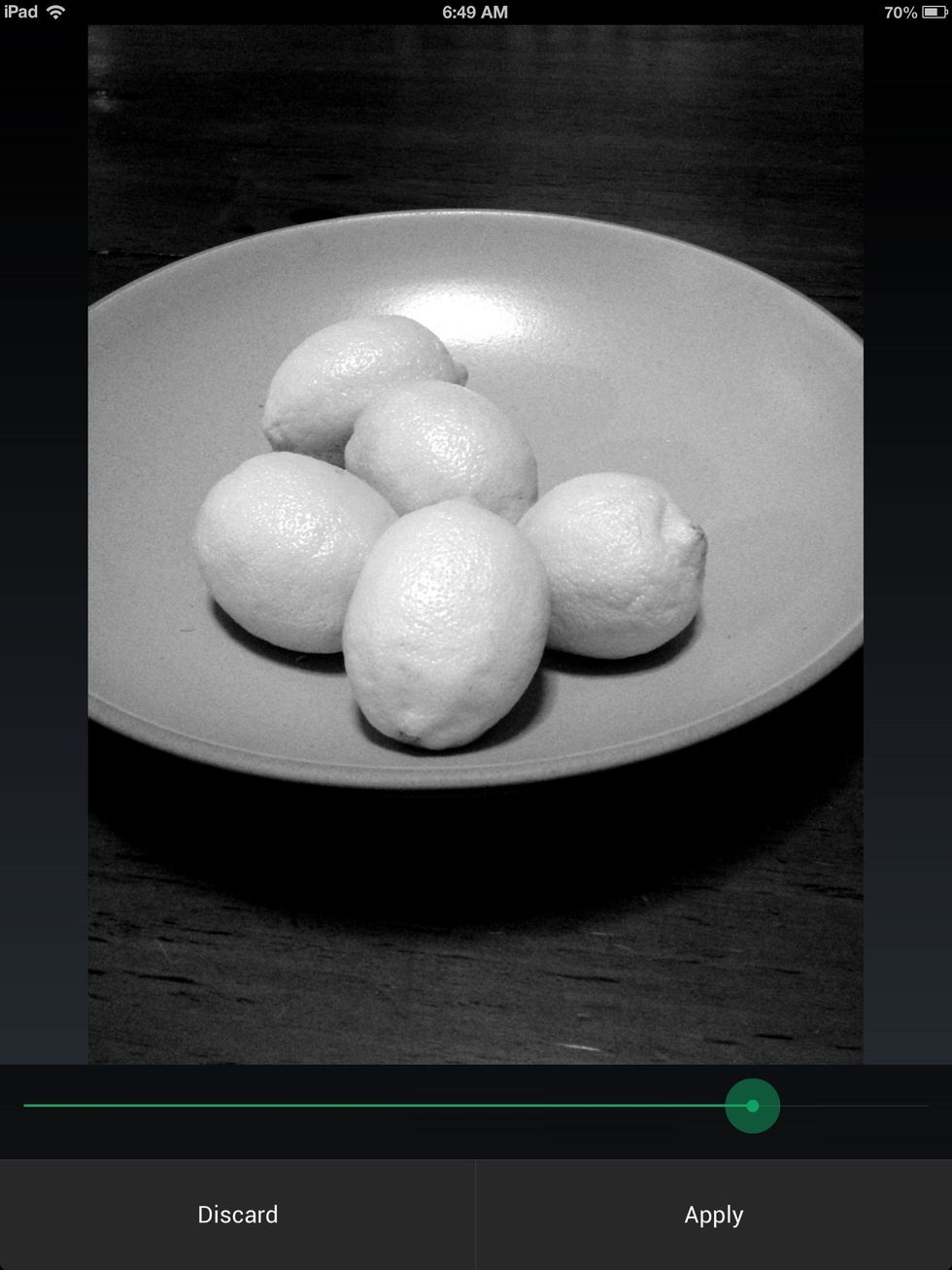 Tap on Filter. Select 'B&W' option. Adjust contrast to desired effect.