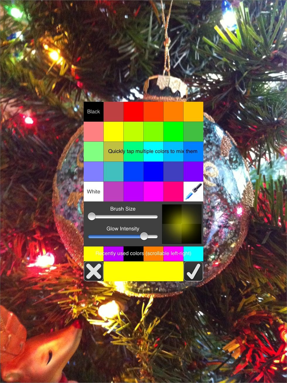 Tap on the color palette in the lower right. Select a color. Move the sliders left or right for brush size and glow intensity. Tap the check mark.