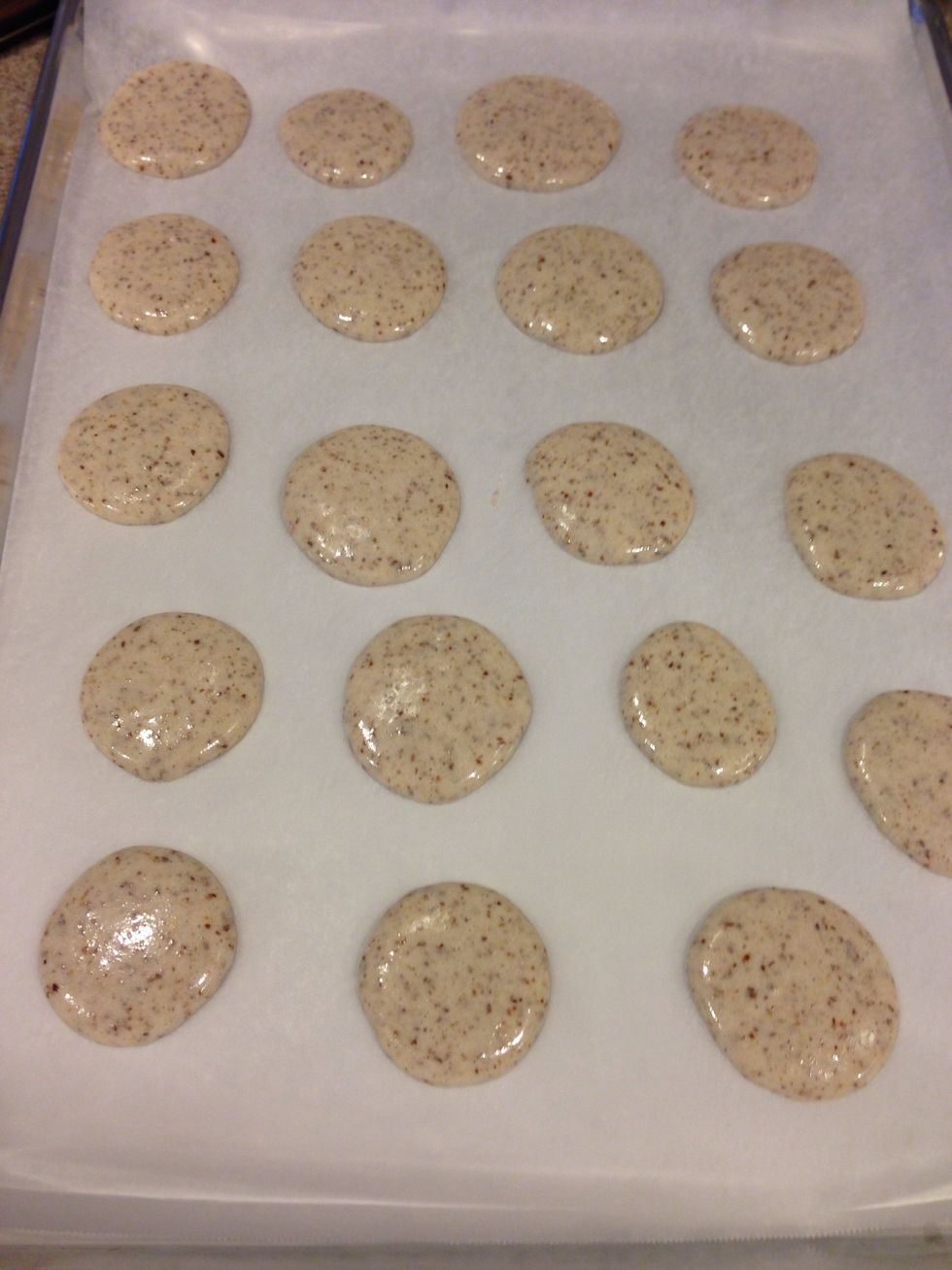 Tap the baking sheet onto your counter several times to get air bubbles out and this helps give the macaron it's shape. Then LEAVE YOUR MACARONS TO AIRDRY FOR 30 min!! Very crucial step!