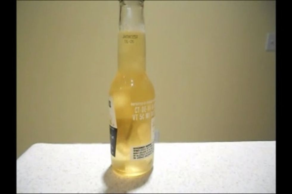 Tap the bottle on a table to disturb the liquid and you'll see a little ice form inside the bottle (see white fuzzy ball in the bottle).