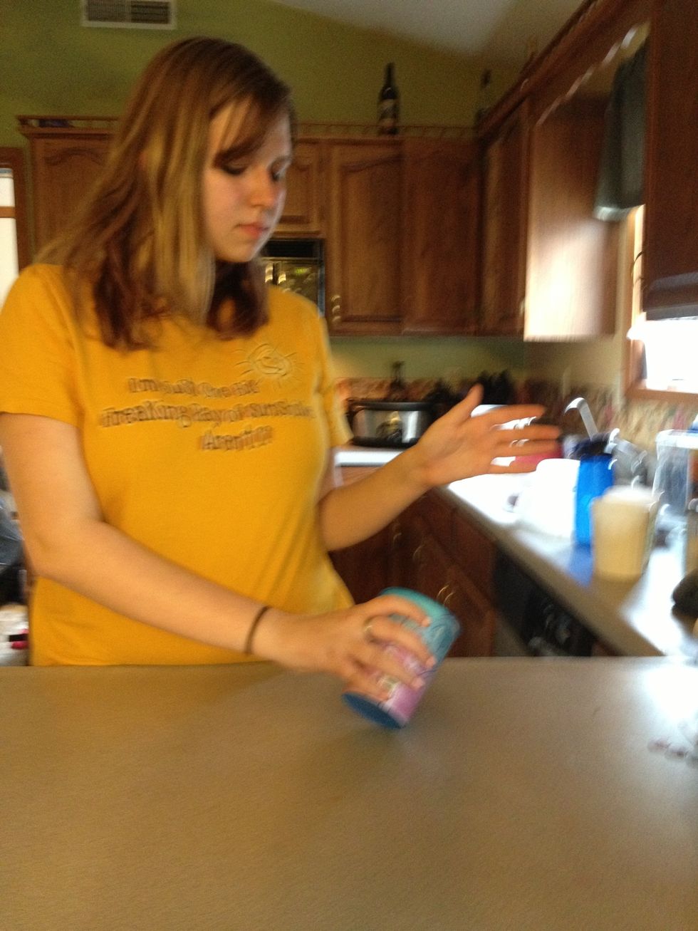 Tap the bottom of the cup (only one side of it) and hit it against the counter.