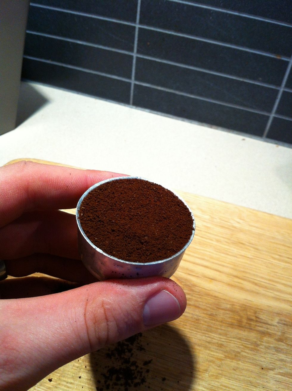 Tap the funnel on the bench to evenly distribute. Then level off the coffee with the back of a knife or something flat so it looks like the picture.