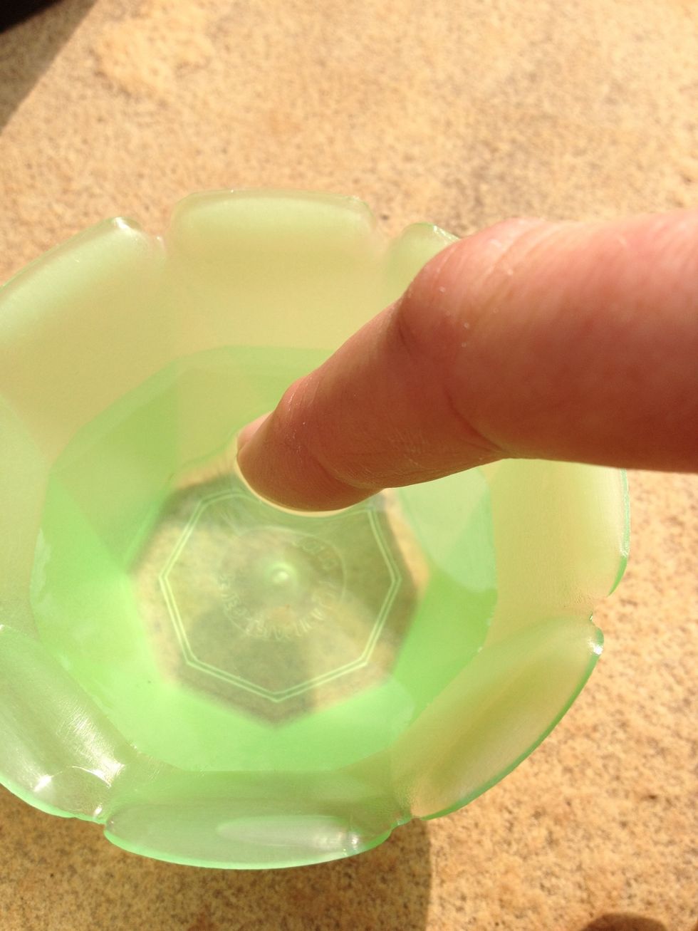 Tap with your finger in the water to get small amounts of water on your finger. Turn your iPhone face down and put a water drop on the camera eye. Then turn quickly your iPhone face up.