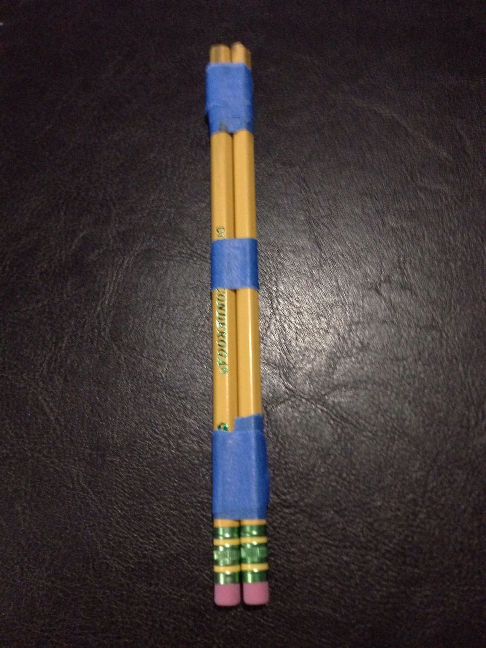 Tape 2 pencils together. Tape: 1 in. from the eraser, 1 centimeter from the unsharpened end of the pencil and in the middle.