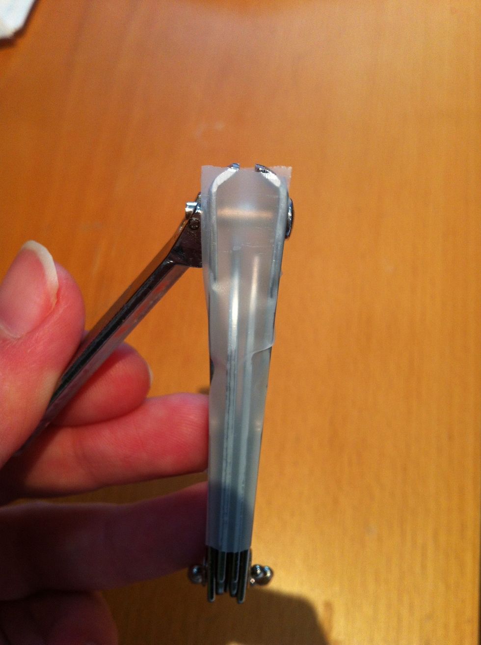 Tape both open sides of the nail clipper and make sure the tape is placed at the top edge of where you will be cutting.