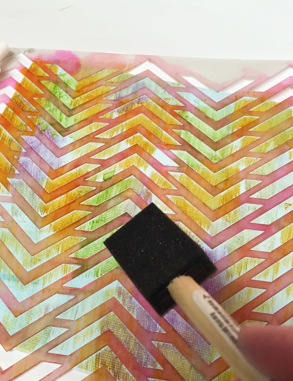 tape CHEVRON stencil over 8 X 10 canvas and randomly fill in portions of the designs using Safran, Amethyst and Cactus inks mixed with a bit of Opaline Izink. slightly blend inks where they meet.