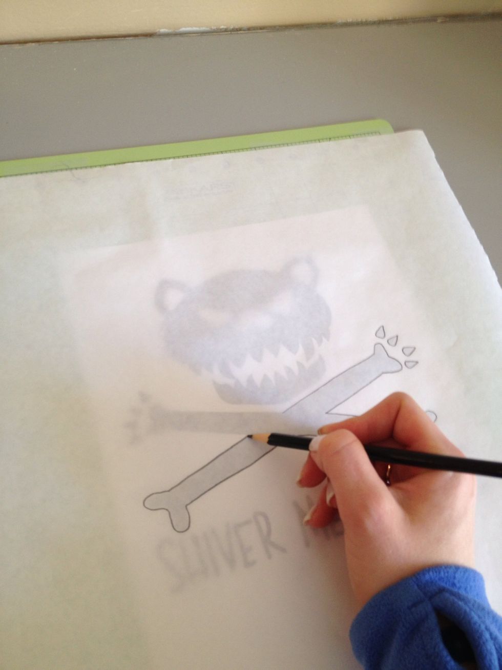 Tape down freezer paper (wax side down) over your design on the cutting mat.