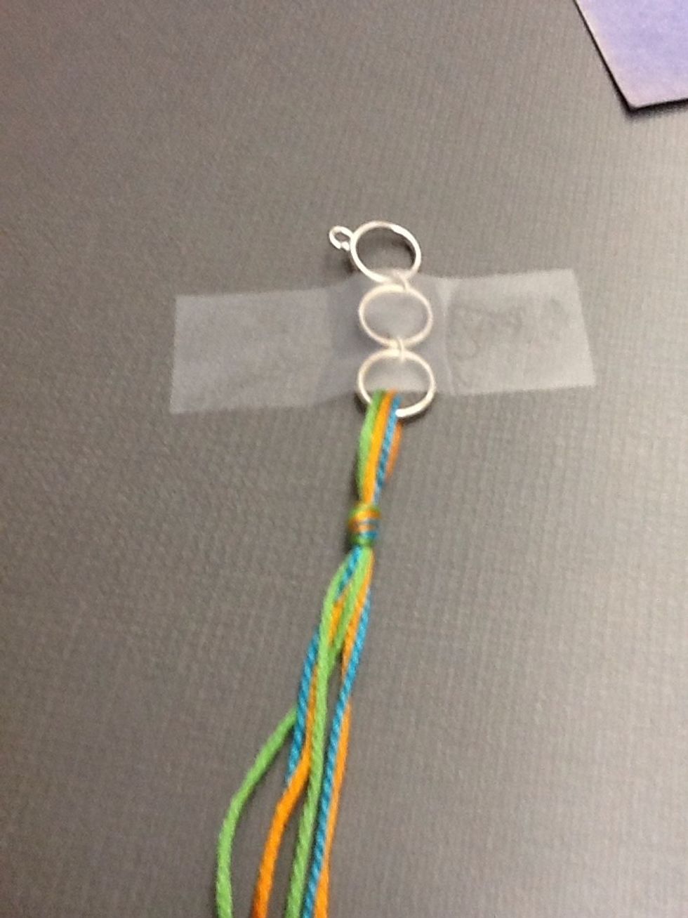Tape down the ring or rings.  Secure them to a table or any flat surface.