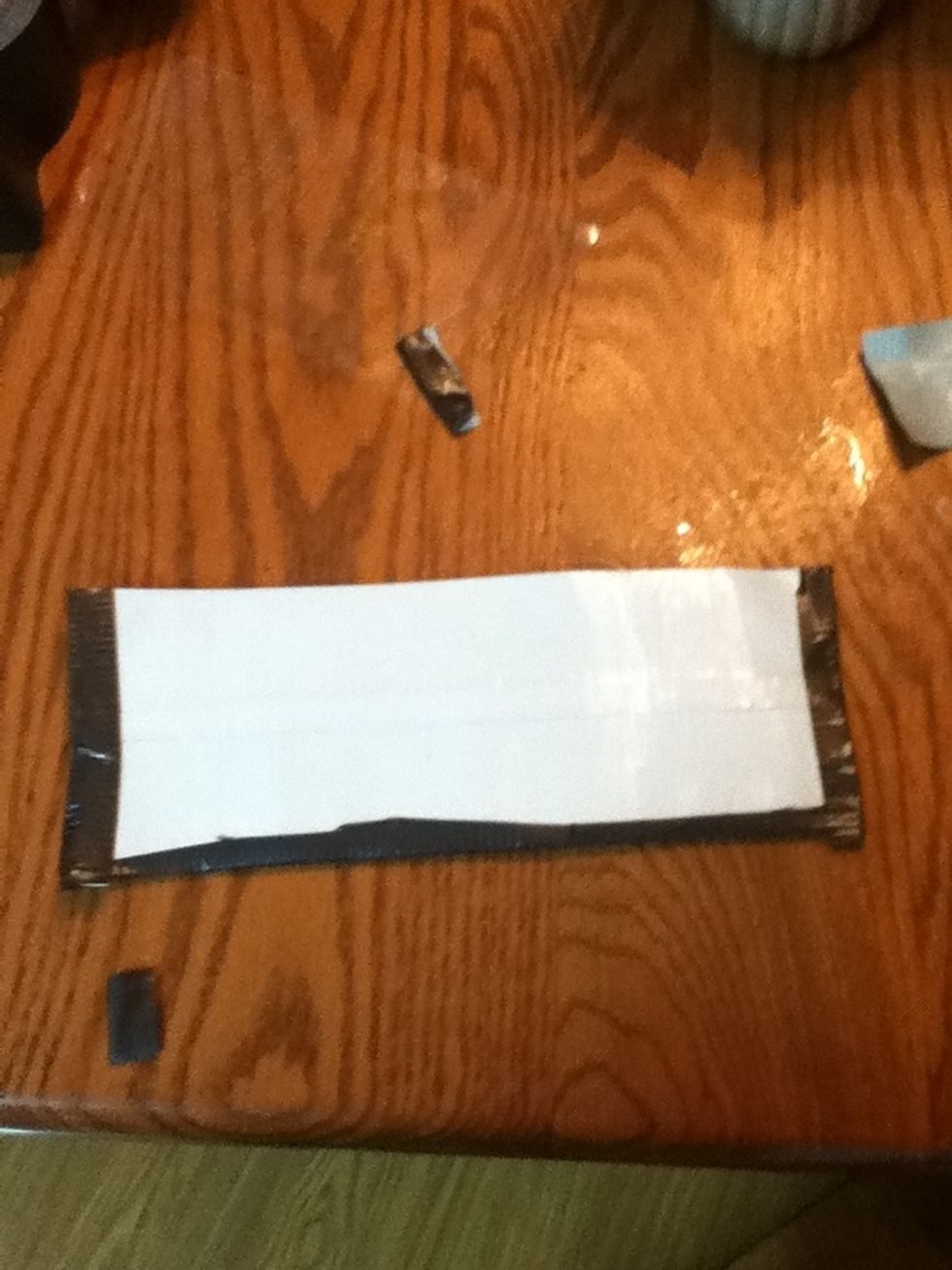 Tape it to the sides and put another half of it on the card side and your finished:)