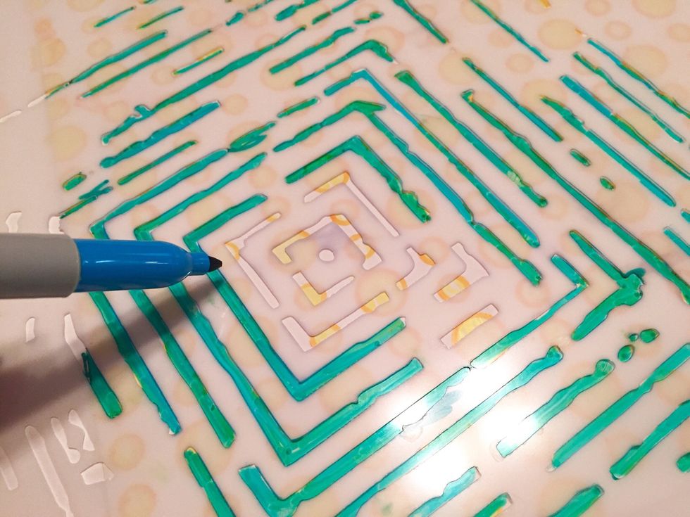 tape Labyrinth stencil over sheet with circle designs. use Aqua Sharpie to fill in designs. reposition and retape stencil as needed to cover sheet with designs.