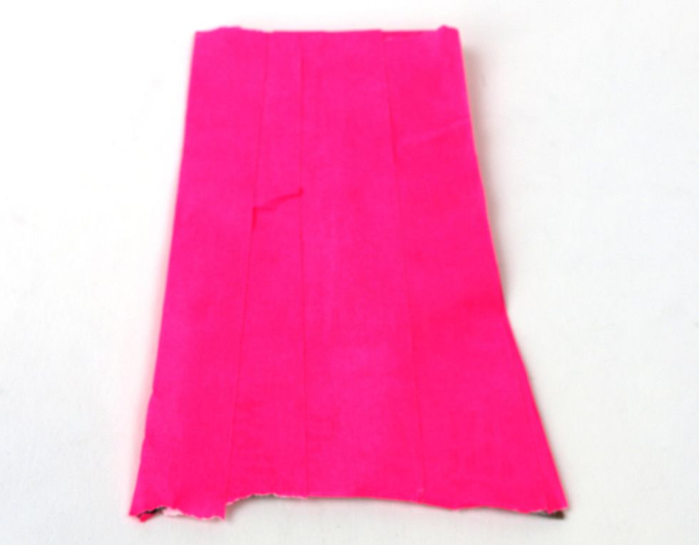 Tape over the back of the newspaper as well to finish your cape.