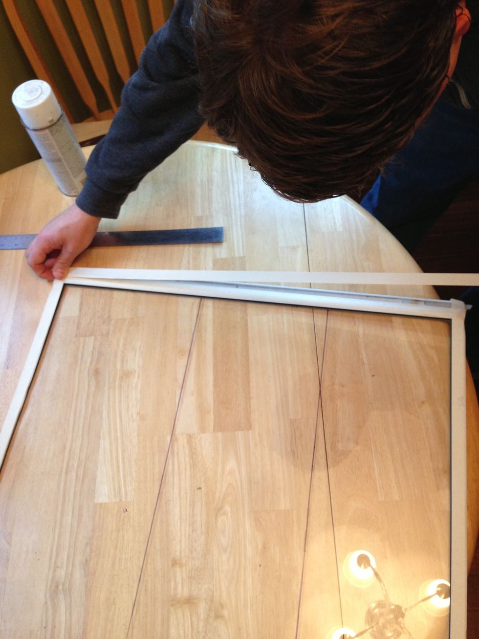 Tape over the edges on the back side of the frame to protect it from the spray paint.