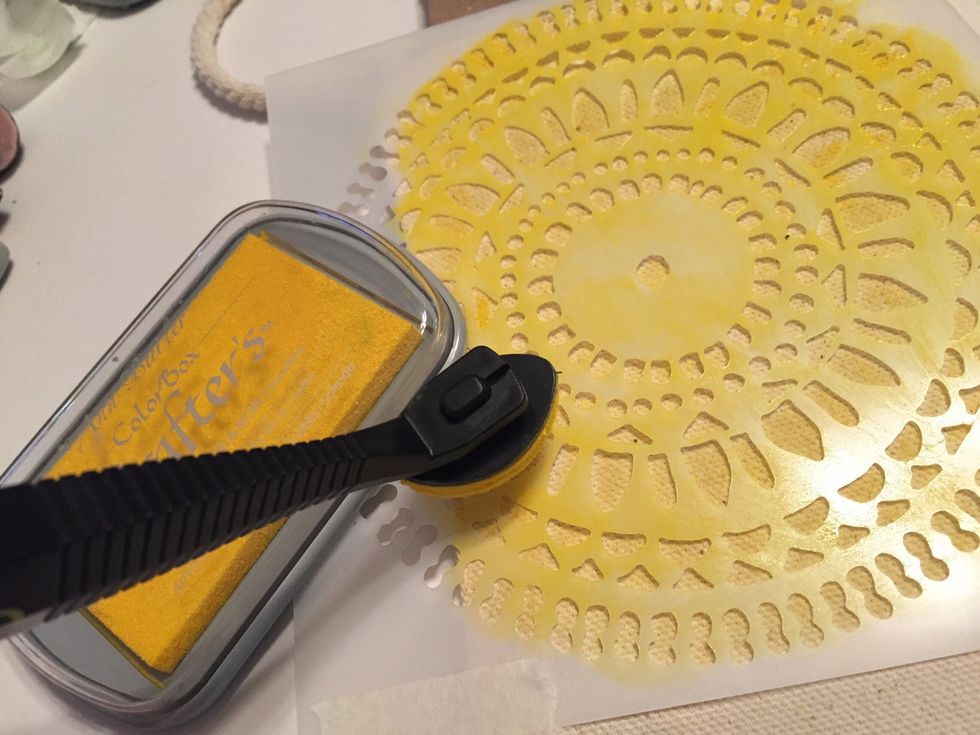 tape Stone Rings stencil at upper left on back of bag. begin inking with Sunshine Ink.