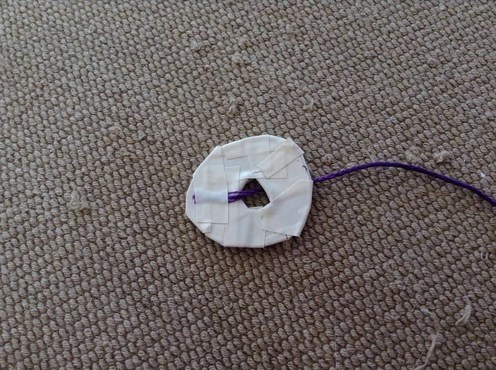 Tape the end of the string to the ring. And just start wrapping the ring with a colorful string