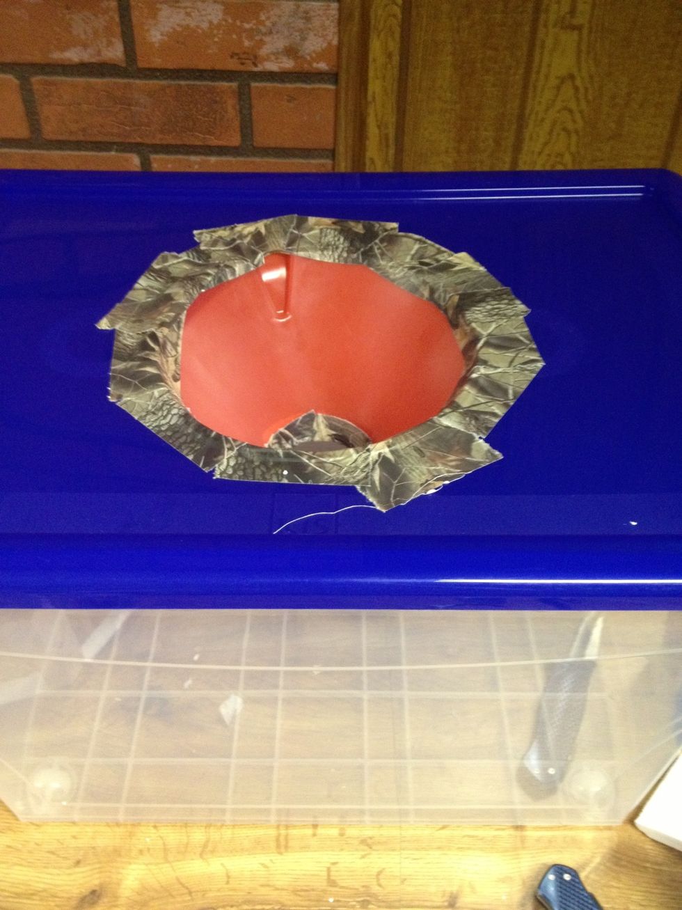 Tape the funnel down on to the lid of the tub like so...