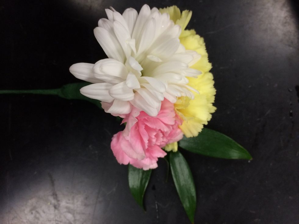 tape the greenery on either the side of the flowers or the back.