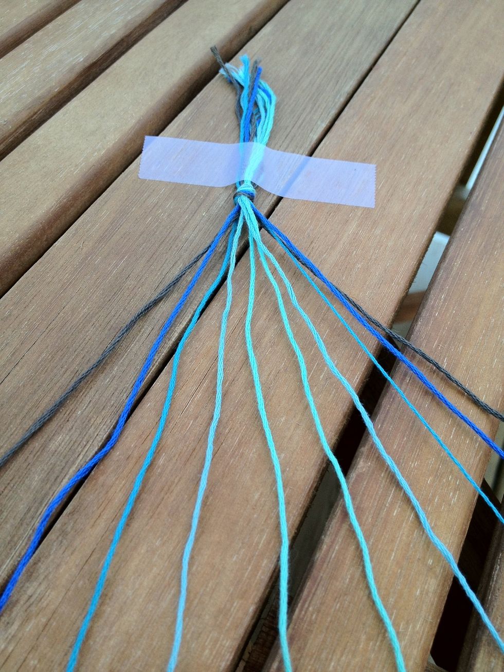 Tape the group of strings to a flat surface, or pin them to your pants, whatever works best for you. Line the strings in the order you want them and mirror them on the other side.