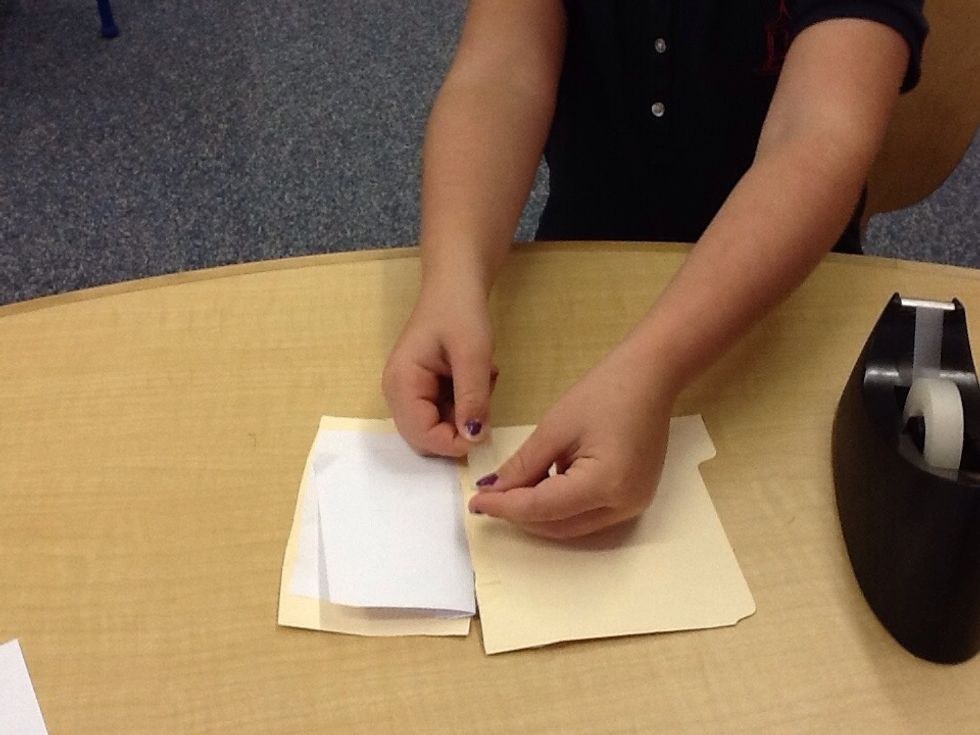 Tape the paper and cardboard together to make the book.