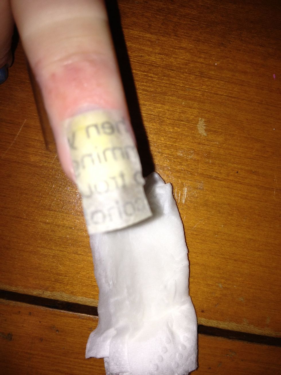 Tape the paper to your nail, but make sure there are no tape on the parts you want on your nail. My tape is hard to see, but it's barely on top of the paper, going around my finger.