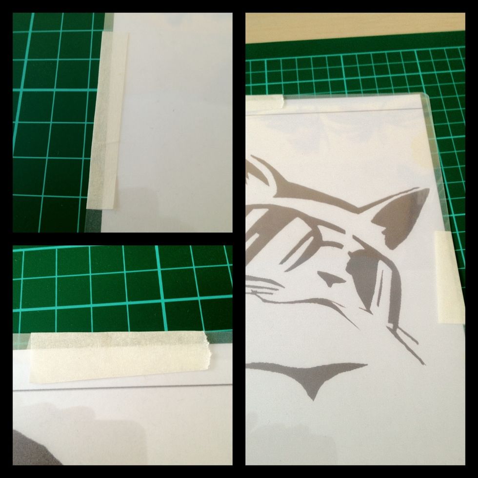 Tape the plastic sheet to your design so they stay together. I find masking/ painters tape is best because it doesn't leave any residue.