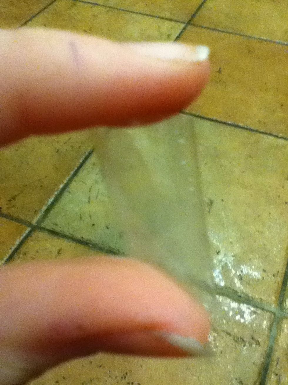 Tape the smaller present to the large one with double-sided tape or simply a rolled-over piece of tape, as shown here.