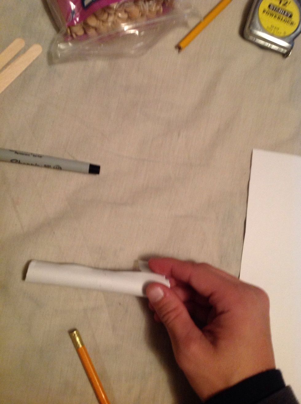 Tape the tube together so it doesn't unroll and do the same process with the other four sheets of paper.