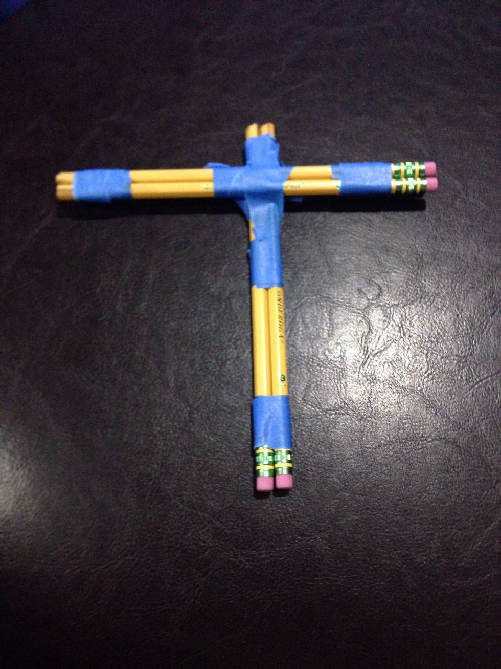Tape the two pencils together so it looks like a lowercase "T" or a cross. One pair of pencils would be taped to the middle, about a centimeter down from the unsharpened end of the 2nd pair