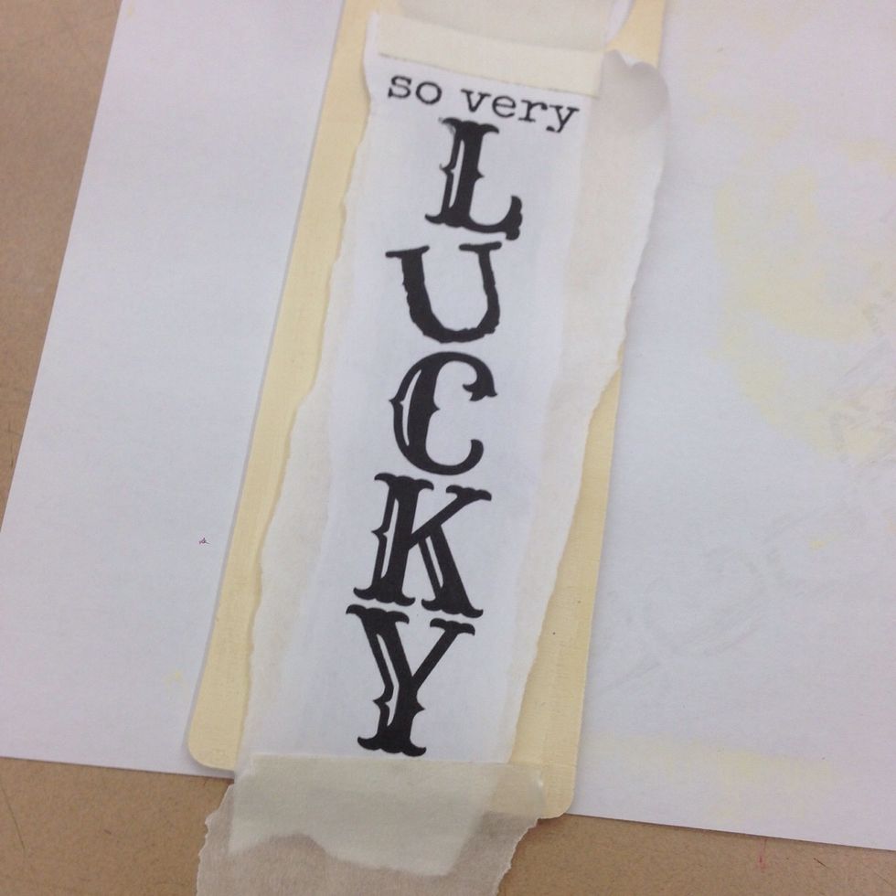 Tape the word art strip to the center area of your door hanger.