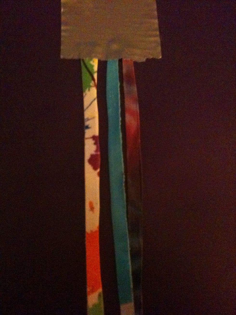 Tape three of the strips down.