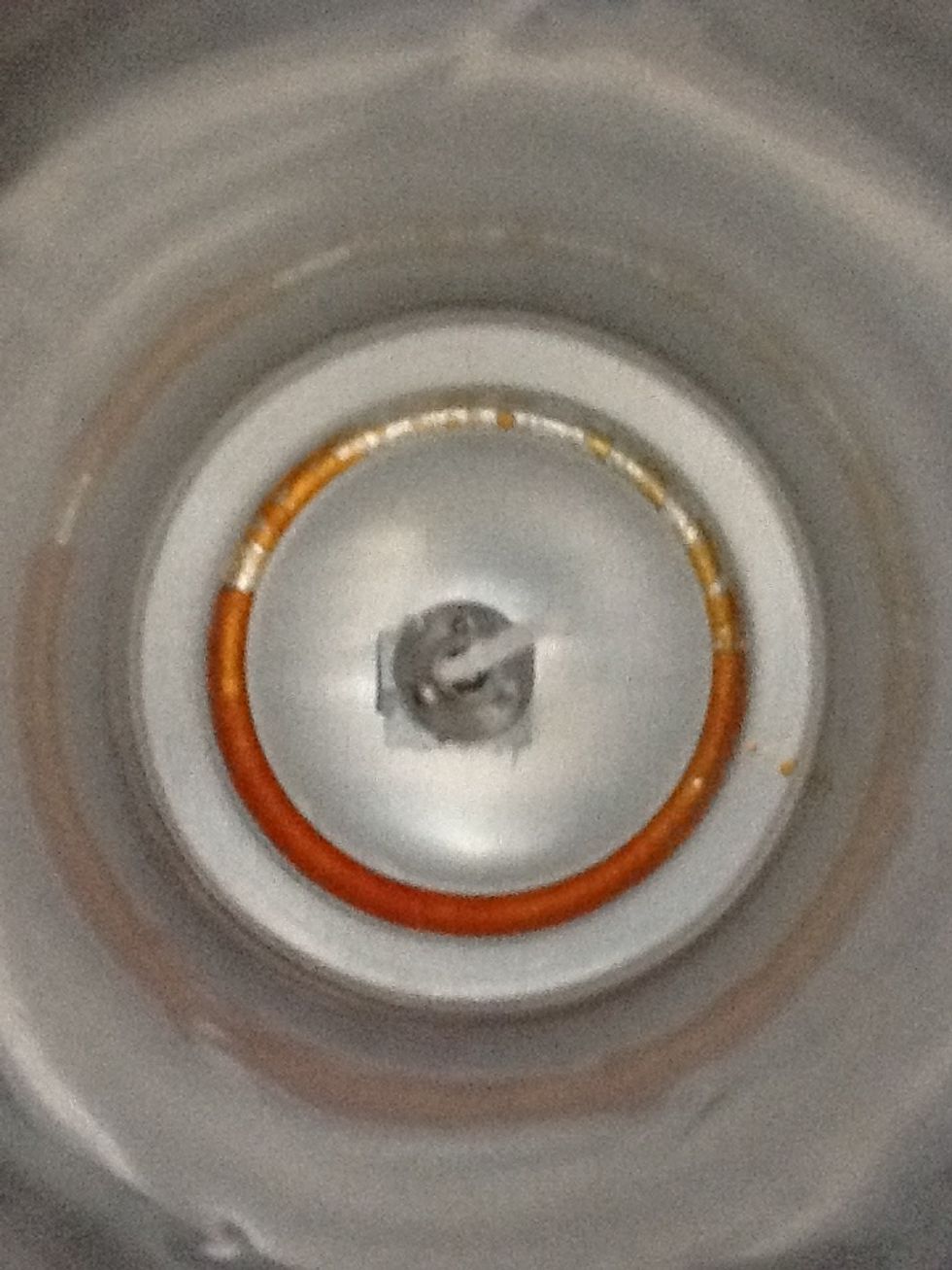 Tape to the bottom of can