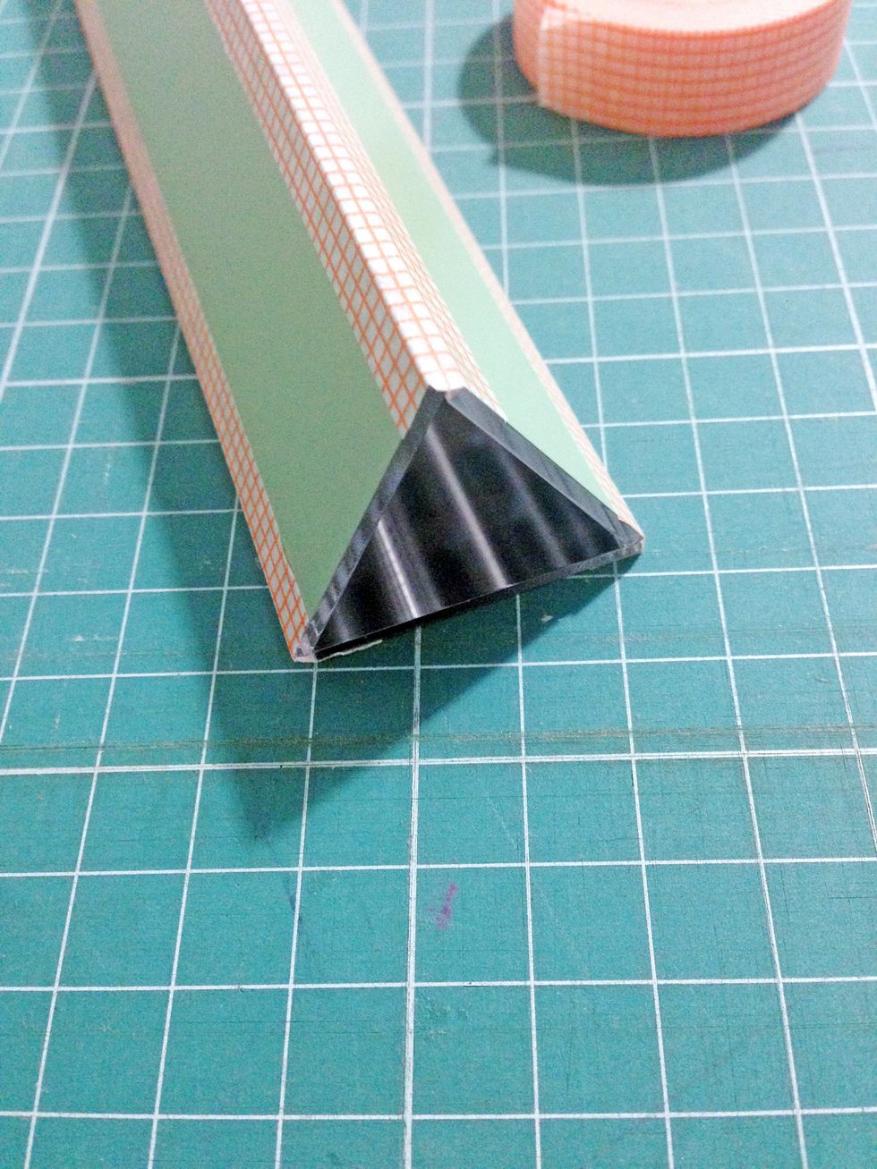 Tape towards the opposite mirror to form a triangle as shown... This will be the prism of the kaleidoscope..