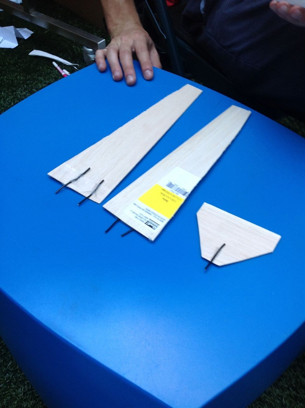 Tape two wires to the bottom of each wing and the last one on the bottom of the tail wing. Watch the next video to assemble your plane!