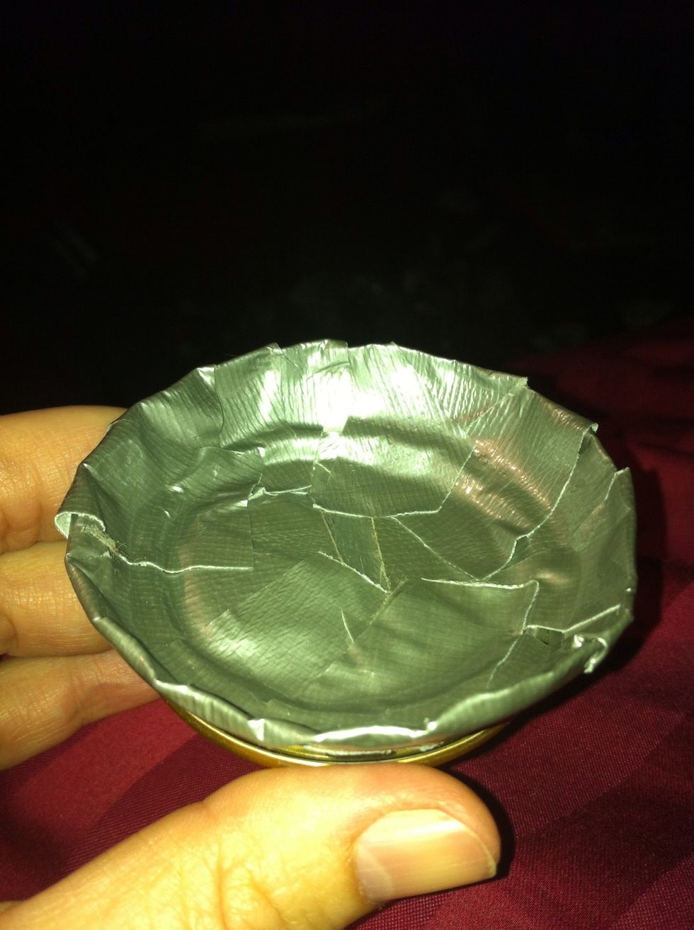 Tape up the cap, closing the hole. I keep the tab as a extra later, but you can pop the tab out if you want