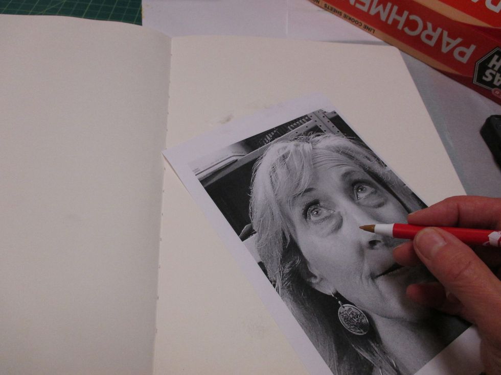 Tape your image to the paper and start tracing your face using a colored ball point pen. Feel free to leave out the wrinkles and dark circles!