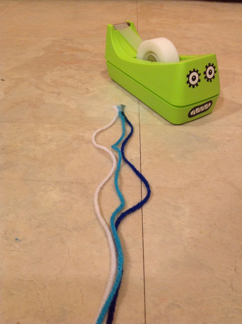 Tape your strings all with the same piece of tape to a hard surface