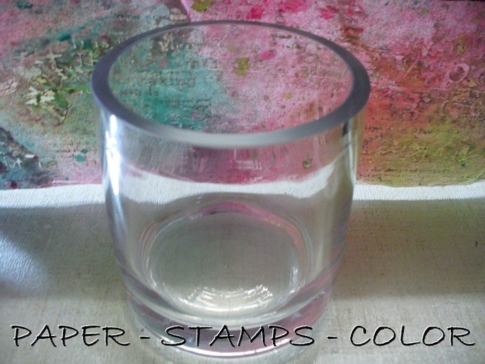 Tear a piece of paper from the background to fit the glass candle holder, plus an inch or so; that will be cut off after glueing it to the holder.