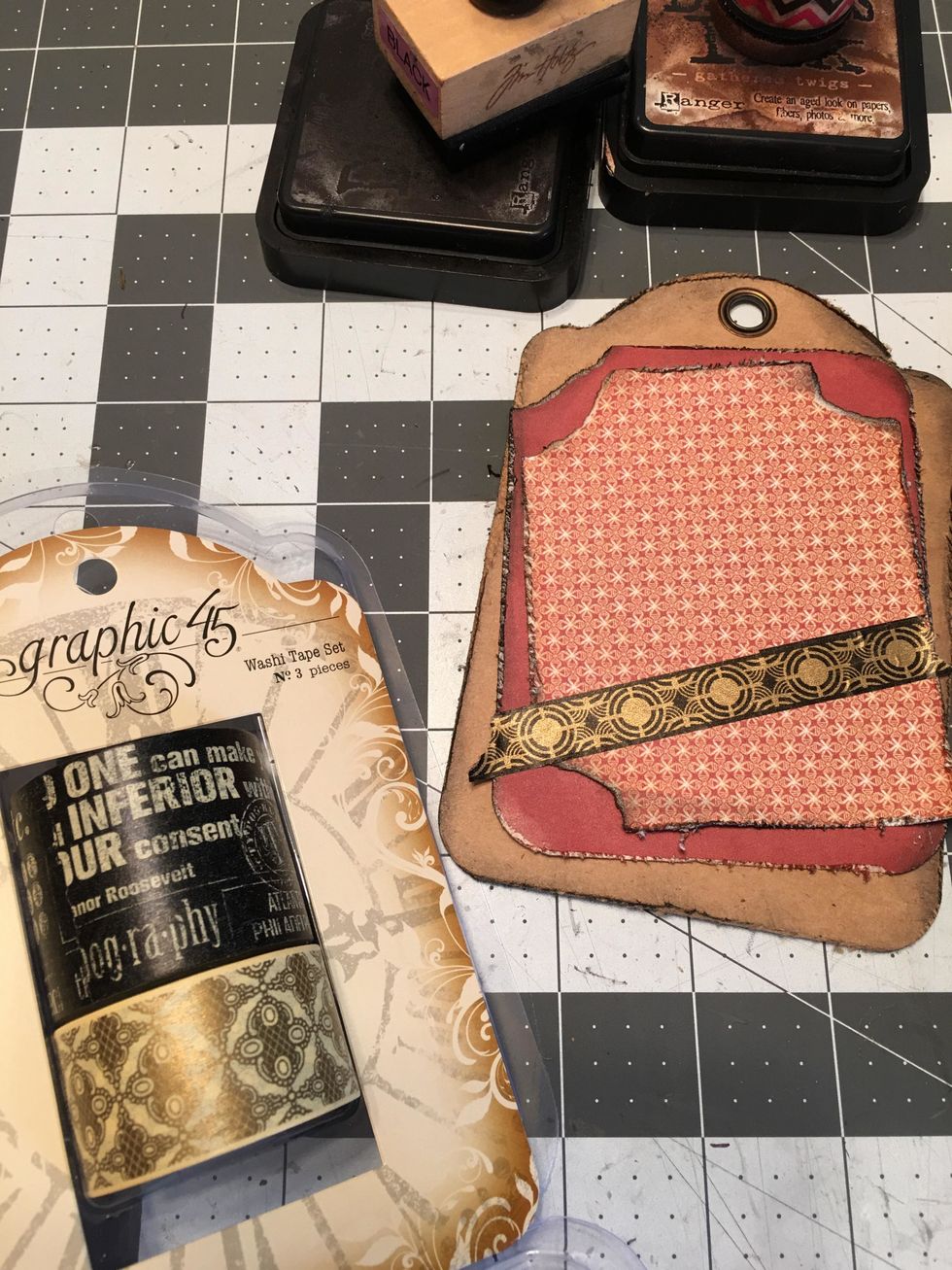 Tear and add a piece of Graphic 45 Washi tape across the bottom of the photo mats or where desired.