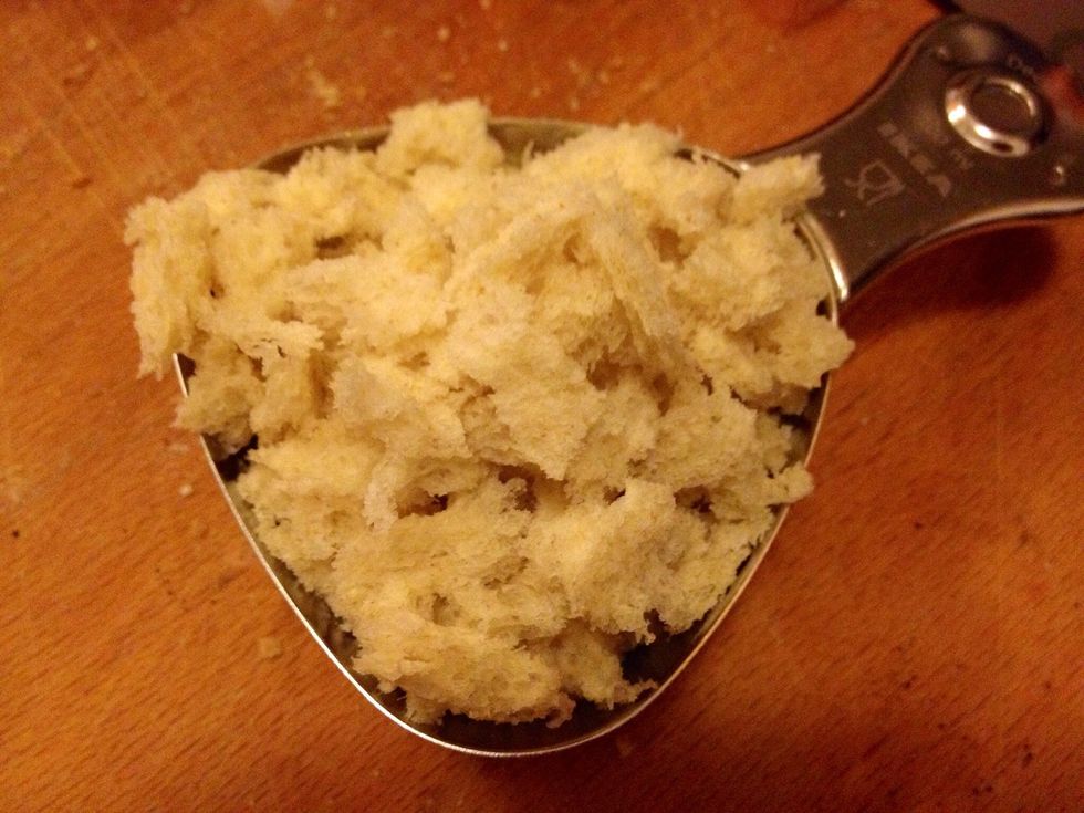 Tear apart 2 slices of white bread.