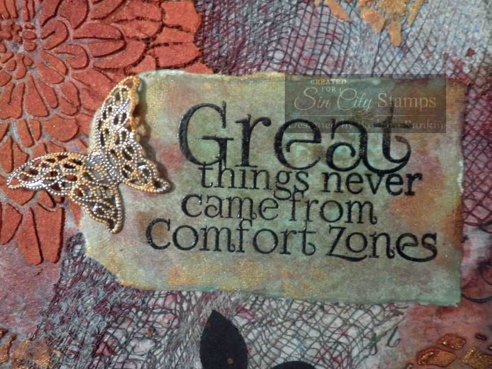 Tear into a tag shape and spray blue, green, Indian Corn and Cork mists over all. Apply Emperor's Gold acrylic glaze sparingly with your finger to the tag. Adhere tag to center of page.