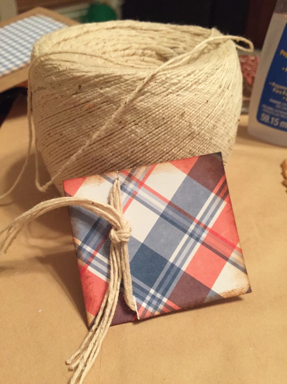 tear "notches" towards left edge of plaid paper and tie with 5 strands of string