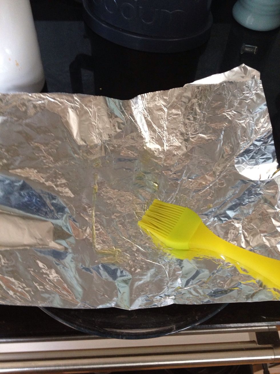 Tear off a large piece of aluminium foil about three times the size of your Salmon.Fold it in half then drizzle a little olive oil on top. Use a pastry brush to grease the centre 1/3 of the foil.