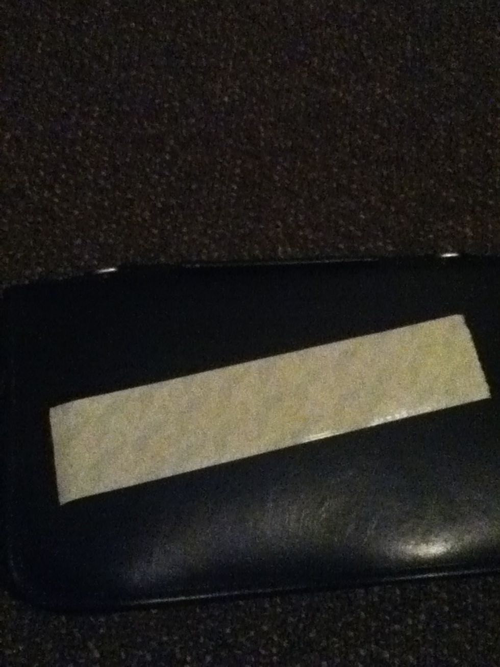 Tear off a strip and set it sticky side up on a solid surface