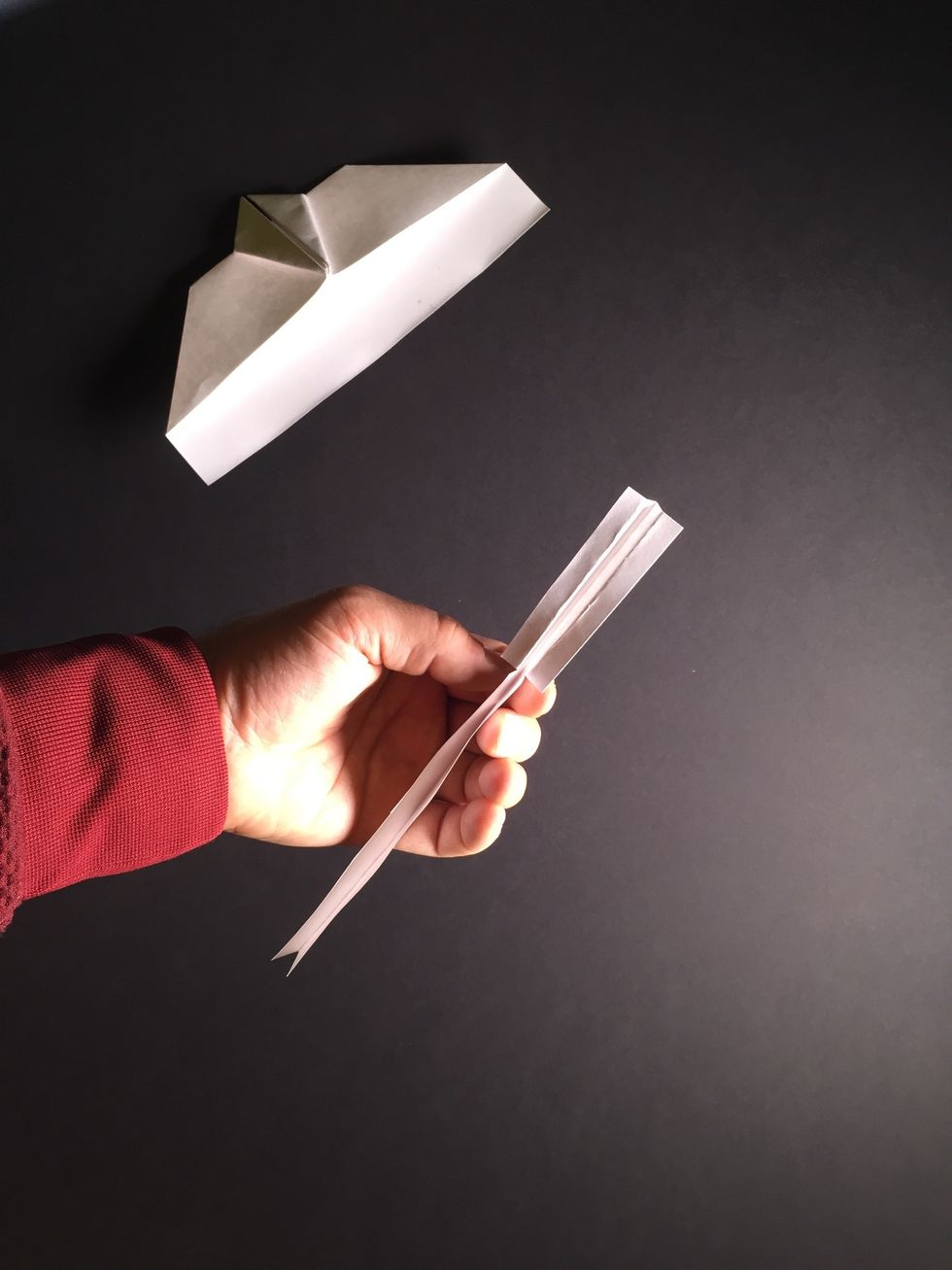 Tear or cut as shown to form control surfaces. The folds should be parallel with the bottom of the trough.