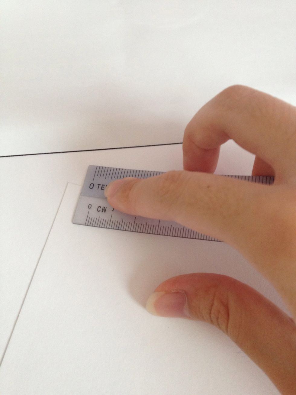 Tear out a piece of drawing block, and fold into half. Rub the creases down with a ruler. Fold over to the other side and repeat to get neater creases.