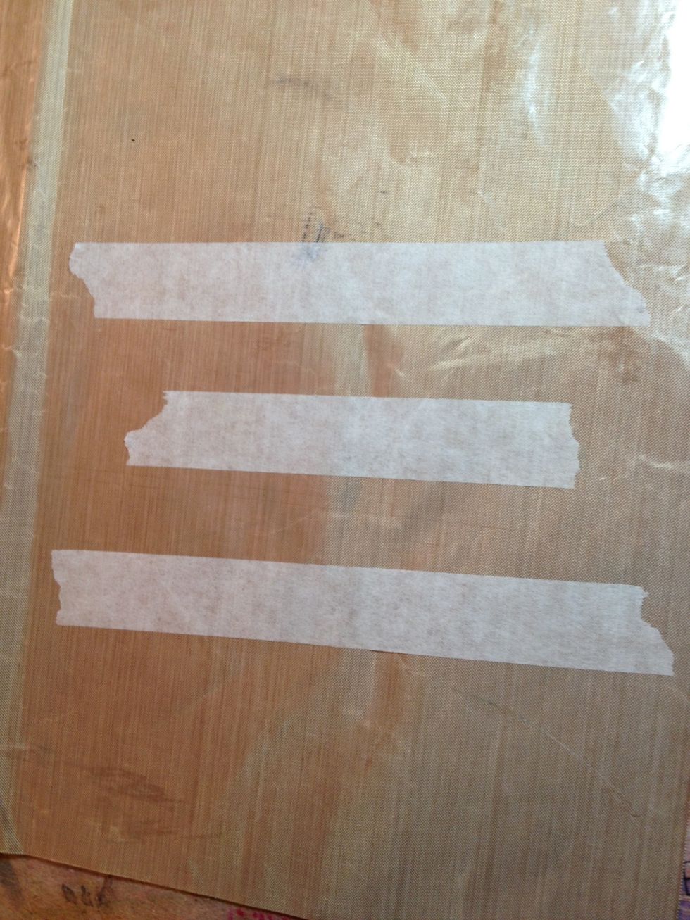 Tear some tape off the roll and stick it onto a non stick craft sheet.