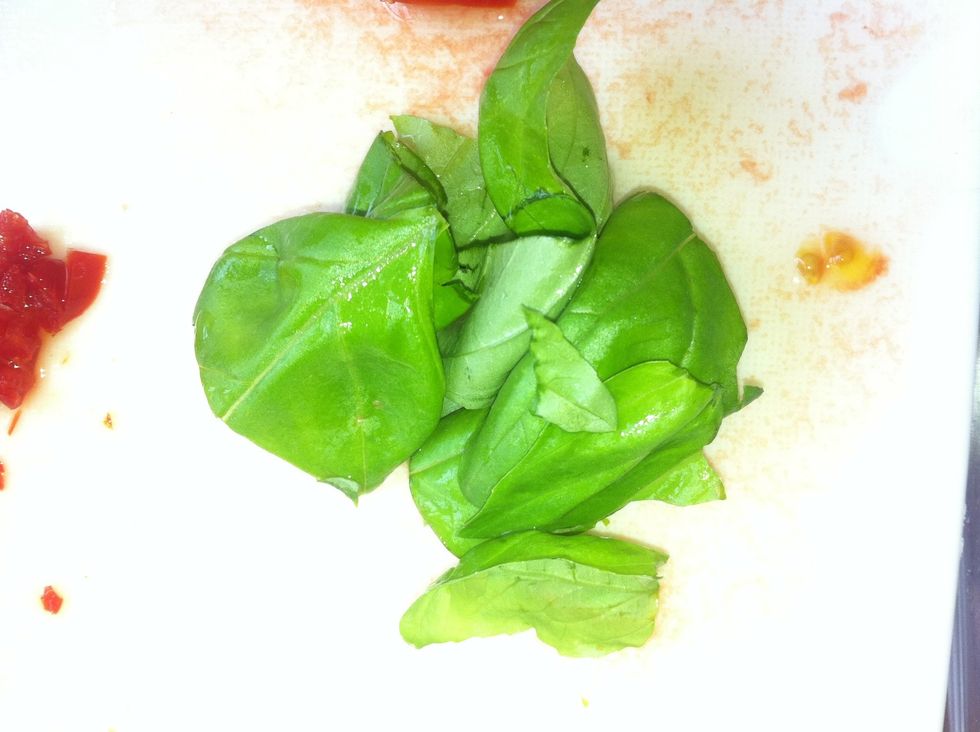 Tear the basil leaves in half