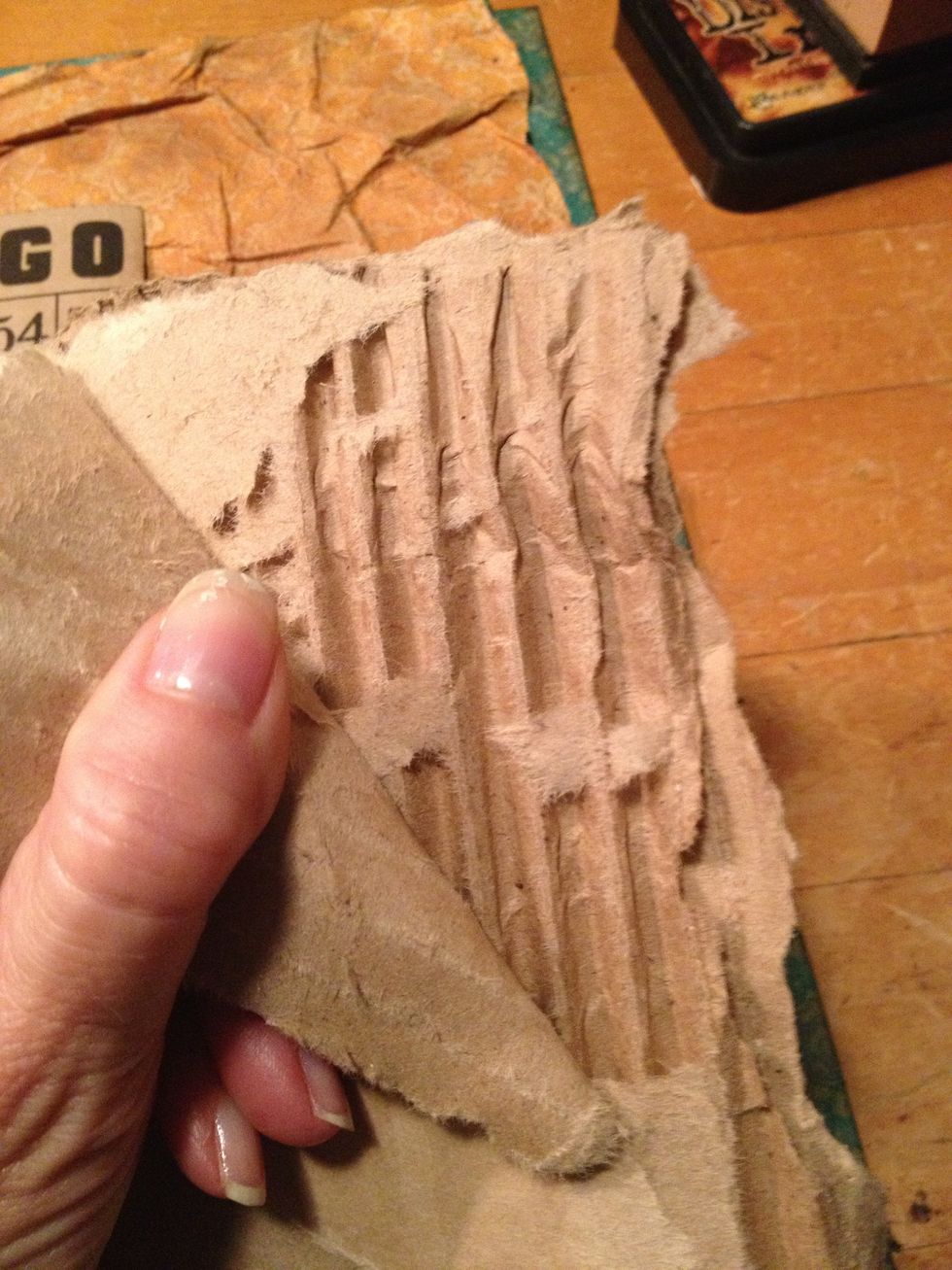 tear the top layers of paper revealing the corrugated layer. tear and distress.