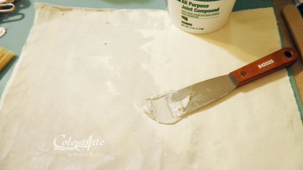 Tear two pieces of unbleached muslin to 11\u2033 x 14\u2033. These will be folded in half to make 7\u2033 x 11\u2033 pages. Use a spatula to spread a thin layer of joint compound on both sides. Allow to dry.