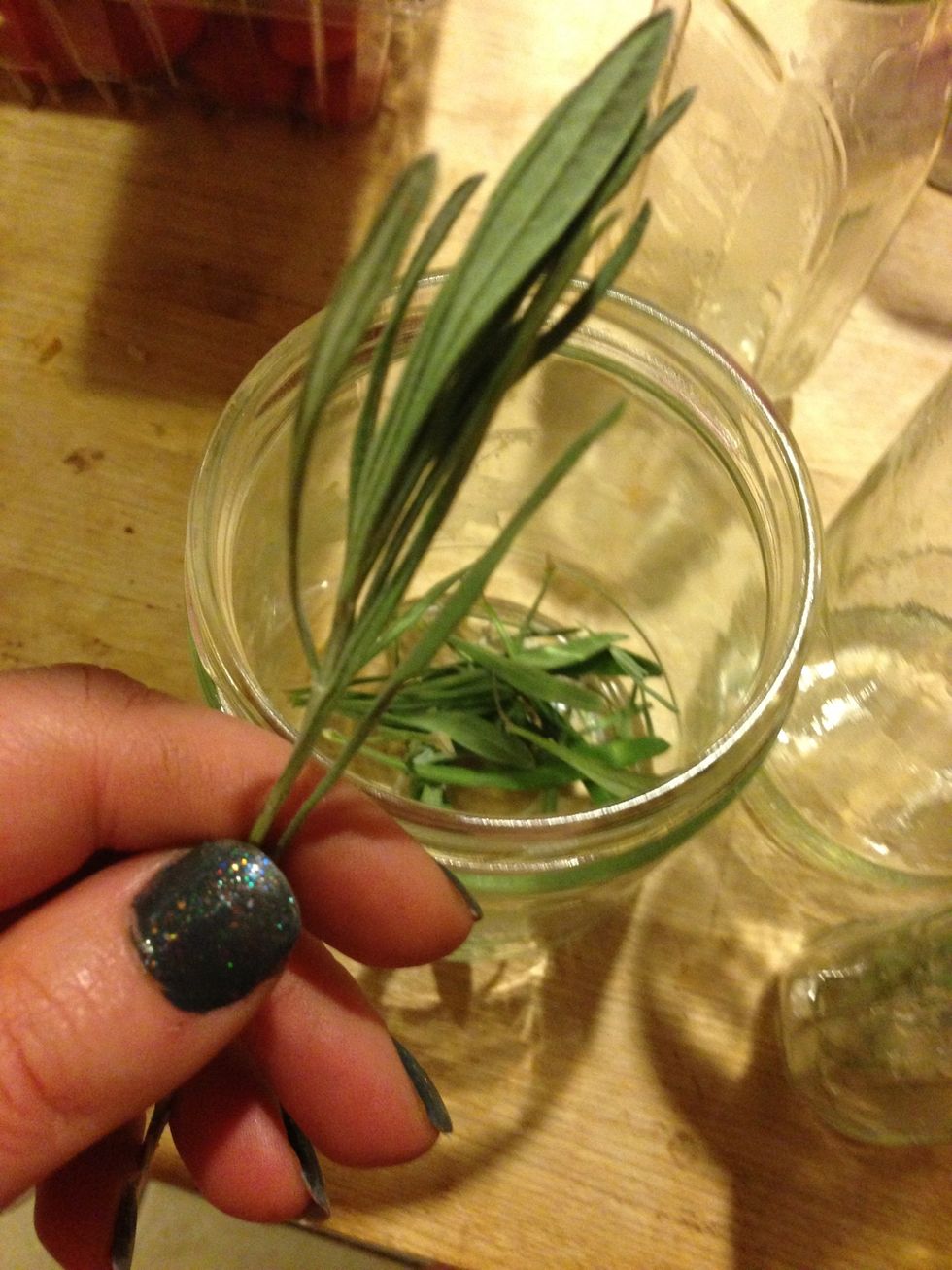 Tear up a bunch of herbs and place in the jar.